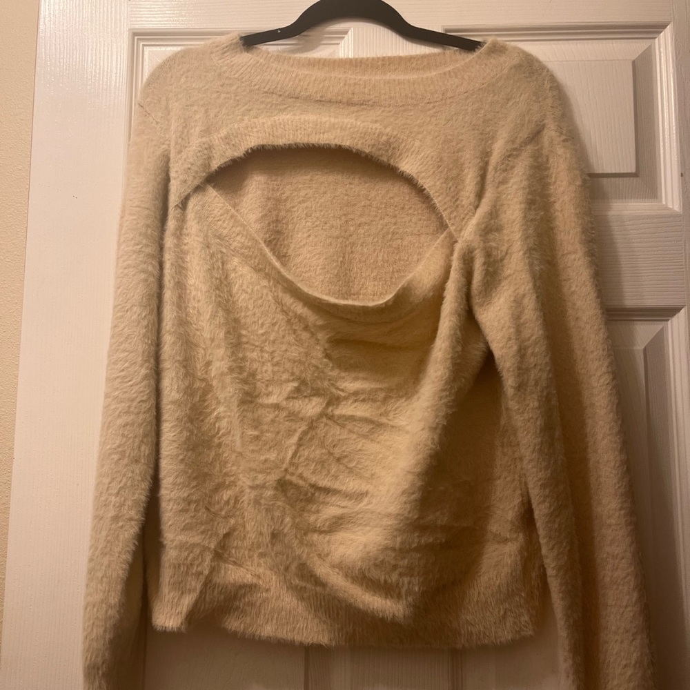 Super cute sweater with peakboo details.